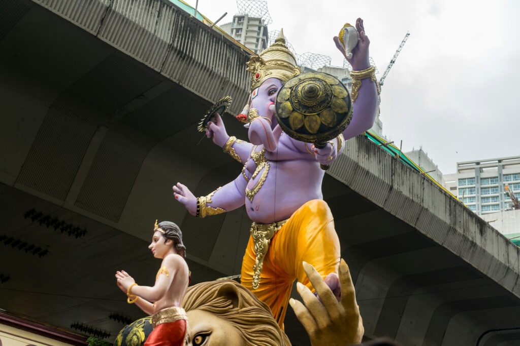 A large Ganesha idol arriving in a festive procession