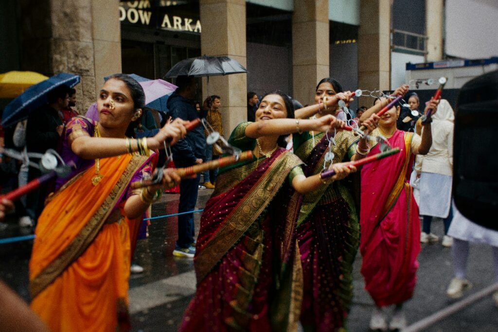 Dancers in traditional saris playing dandiya