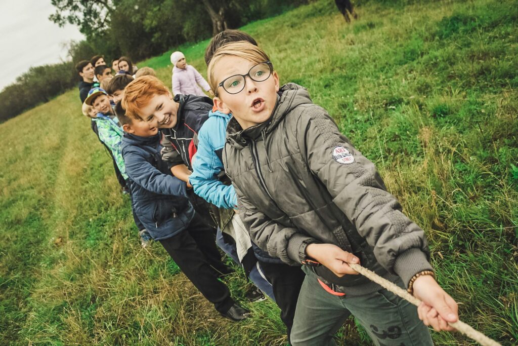Children pulling together in a tug of war
