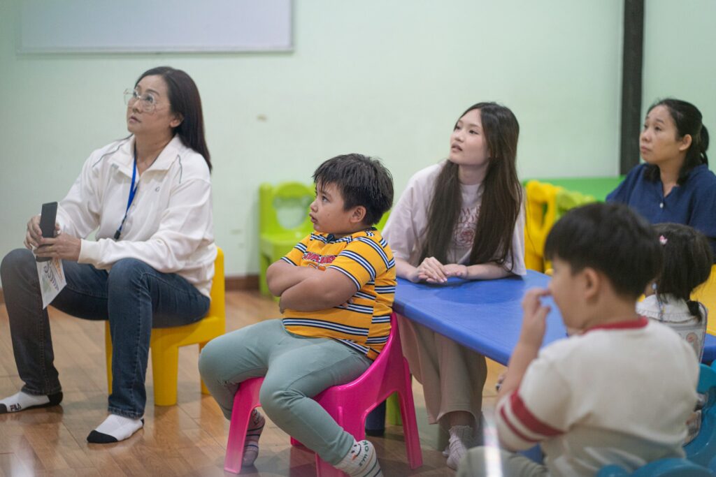 Teachers and children together in a classroom