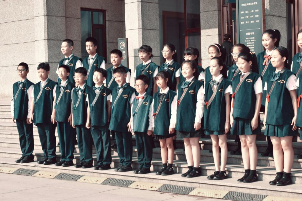 A group of children standing in front of a historic building